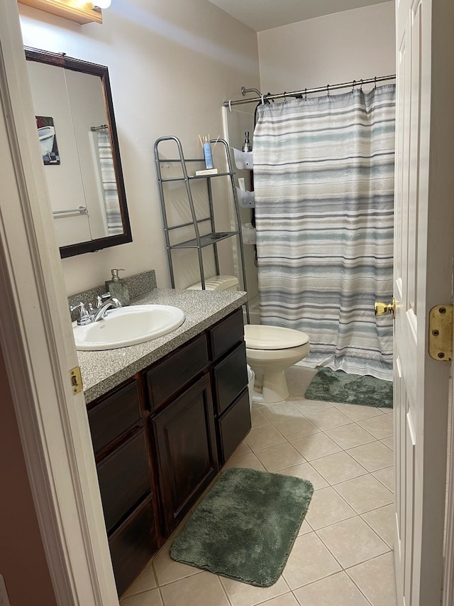 bathroom with tile patterned floors, vanity, curtained shower, and toilet