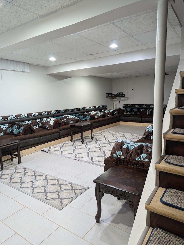 miscellaneous room featuring a paneled ceiling and tile patterned flooring