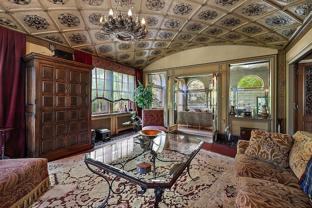 living room with a notable chandelier and lofted ceiling