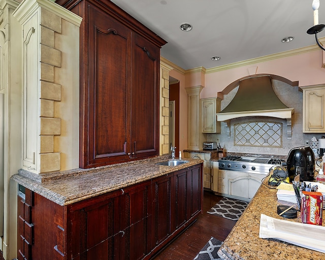 kitchen featuring light stone countertops, sink, dark wood-type flooring, stainless steel gas cooktop, and custom exhaust hood