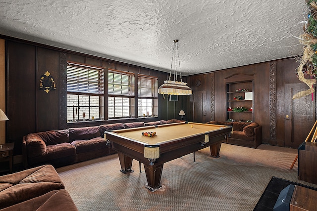 recreation room featuring wooden walls, light carpet, a textured ceiling, and billiards