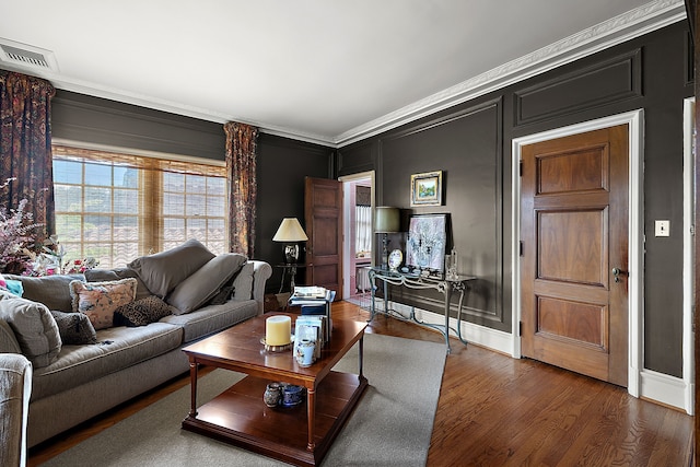 living room with crown molding and dark wood-type flooring