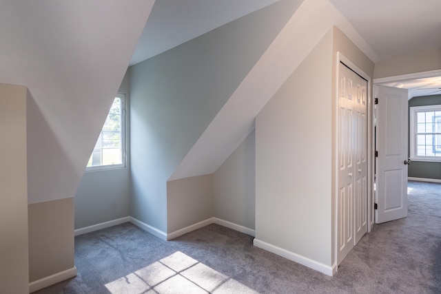 additional living space with light carpet and ceiling fan