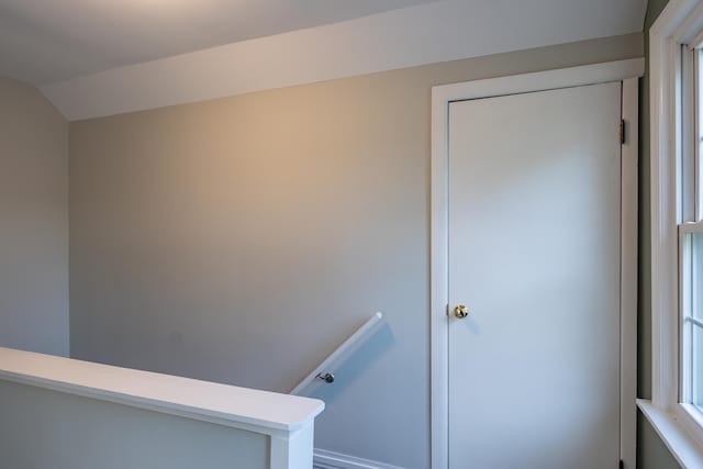 stairway featuring lofted ceiling