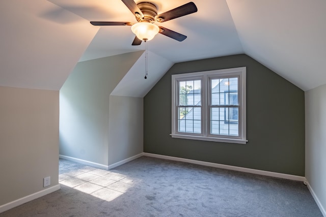 bonus room with light colored carpet, vaulted ceiling, and ceiling fan