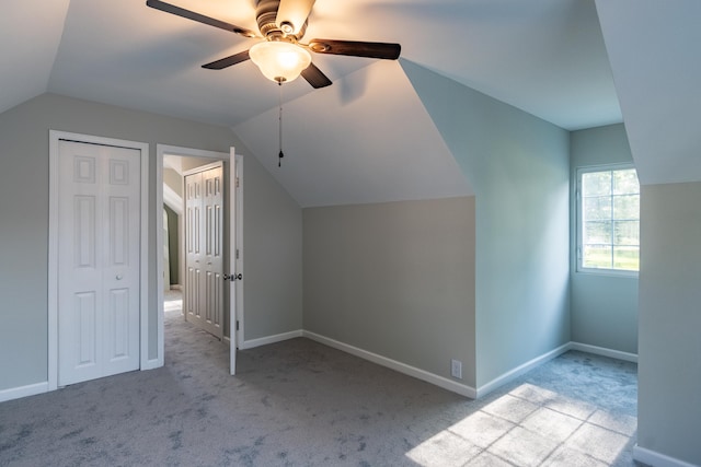 bonus room with ceiling fan, light colored carpet, and lofted ceiling