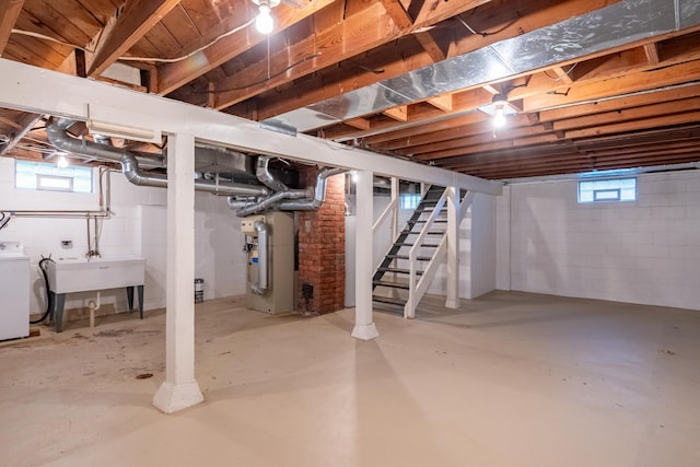 basement with washer / dryer, sink, and heating unit