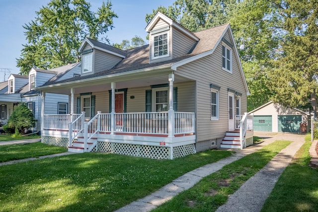 cape cod-style house featuring covered porch, a garage, an outbuilding, and a front yard