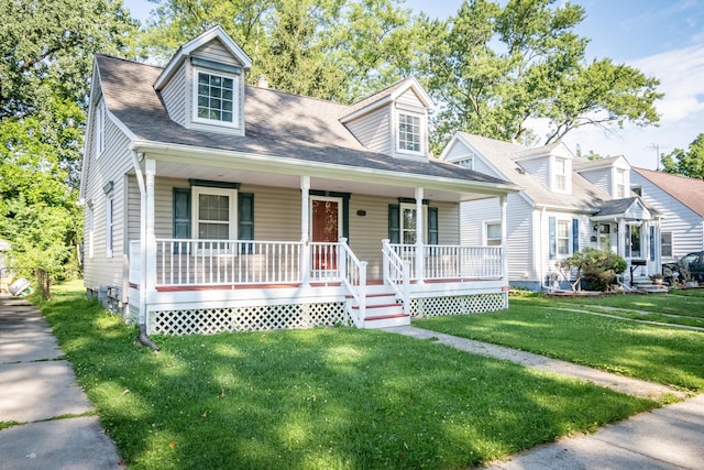 new england style home featuring a porch and a front yard