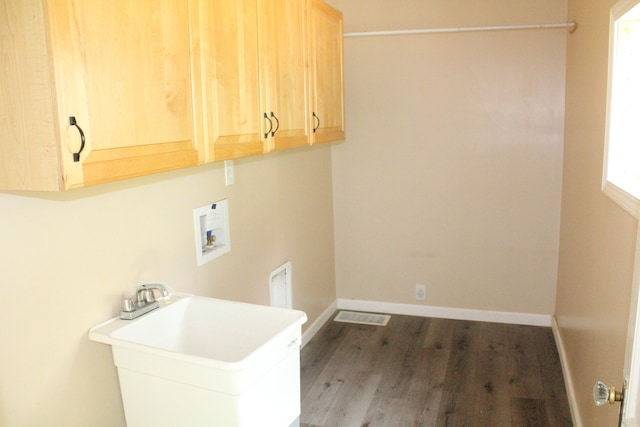 washroom featuring cabinets, wood-type flooring, hookup for a washing machine, and sink