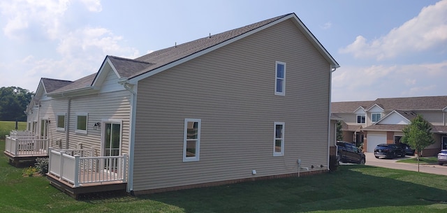 view of home's exterior with a yard and a deck