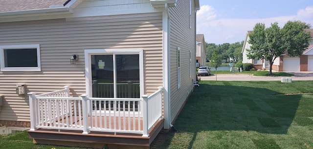 view of property exterior featuring a wooden deck and a lawn