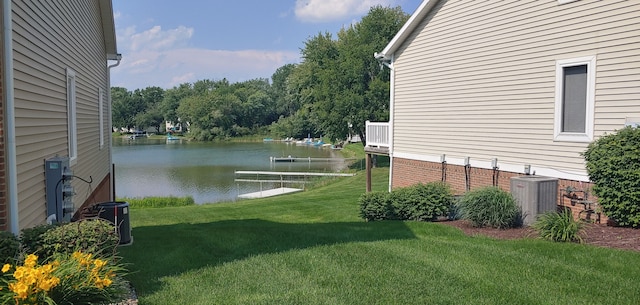 view of yard featuring central AC unit and a water view