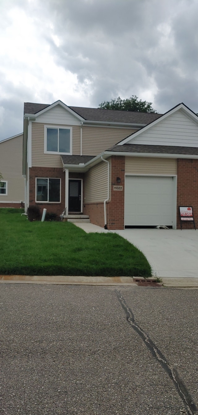 view of front of home featuring a front yard and a garage