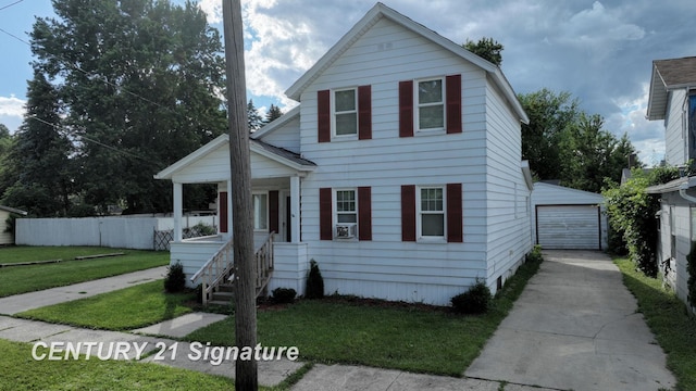 view of front of property featuring a porch, an outbuilding, a front yard, and a garage