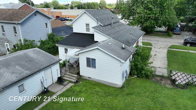 rear view of property with a yard