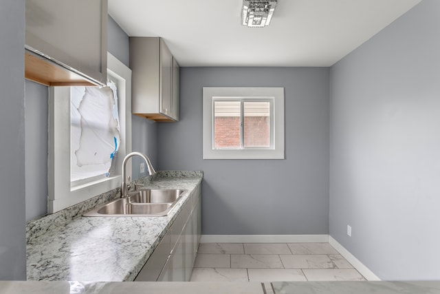 kitchen featuring gray cabinets and sink