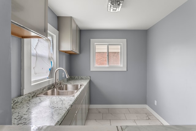 13437 E State Fair St, Detroit, MI 48205 - kitchen featuring a sink, light marble finish flooring, baseboards, gray cabinets, and light countertops