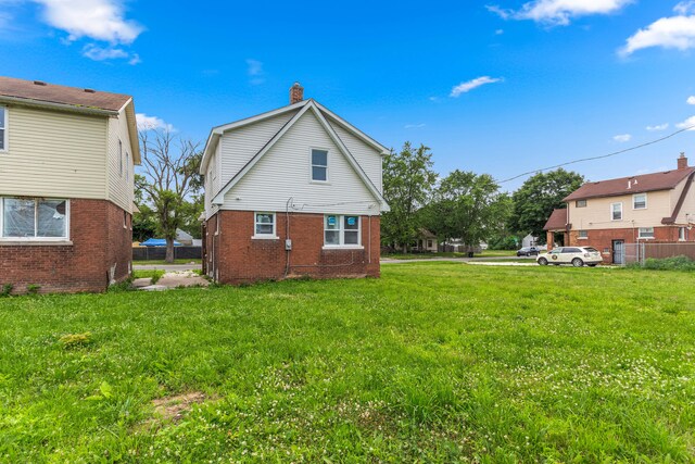 13437 E State Fair St, Detroit, MI 48205 - rear view of house featuring a chimney and brick siding