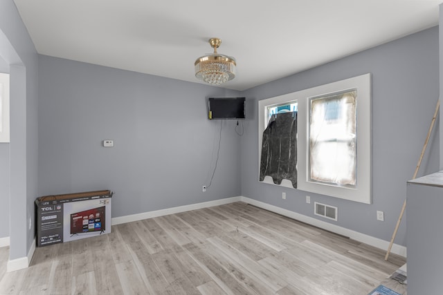 interior space featuring a chandelier and light wood-type flooring