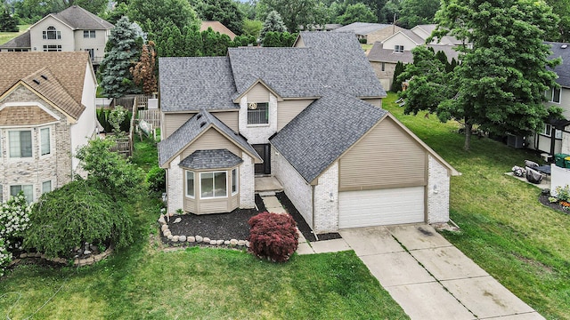 view of front of property featuring a garage and a front yard