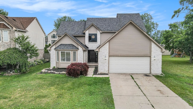 view of front of home featuring a front yard and a garage