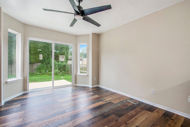 empty room with dark hardwood / wood-style flooring and ceiling fan