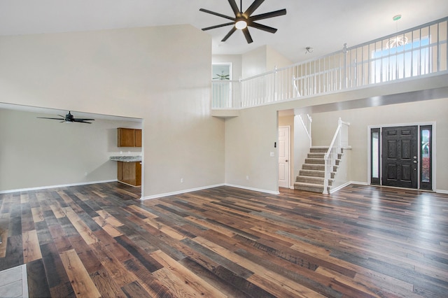 unfurnished living room featuring ceiling fan, dark hardwood / wood-style flooring, and high vaulted ceiling