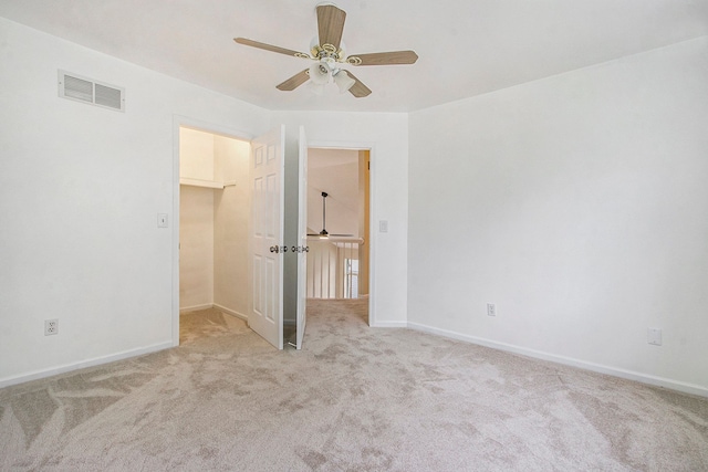 unfurnished bedroom with ceiling fan and light carpet