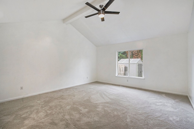 carpeted spare room with vaulted ceiling with beams and ceiling fan