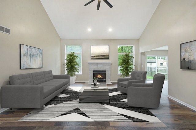 living room featuring ceiling fan, dark hardwood / wood-style flooring, a tile fireplace, and high vaulted ceiling