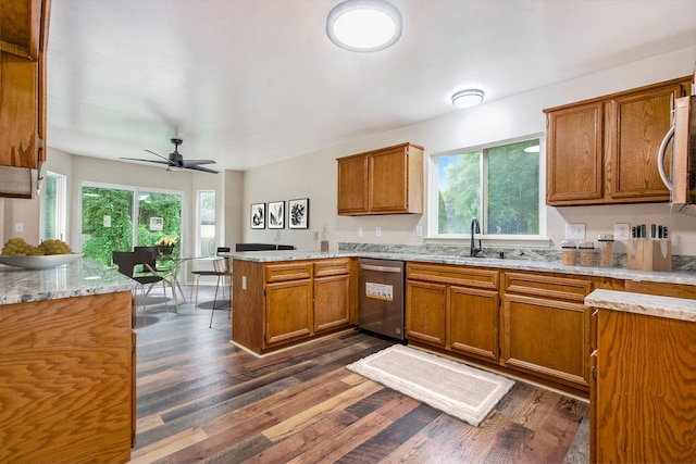 kitchen with kitchen peninsula, a wealth of natural light, dark hardwood / wood-style flooring, and stainless steel dishwasher