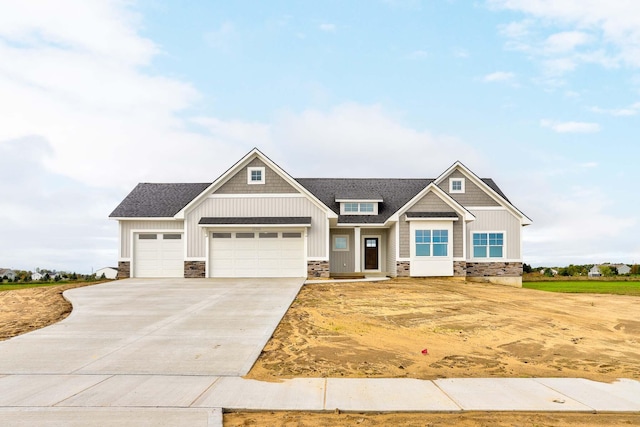 9139 Perry Ct, Zeeland, MI 49464 - craftsman-style home with stone siding, driveway, an attached garage, and roof with shingles
