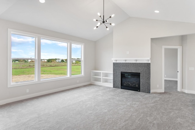 9139 Perry Ct, Zeeland, MI 49464 - unfurnished living room with vaulted ceiling, carpet floors, a chandelier, a tile fireplace, and baseboards