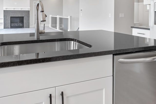 9139 Perry Ct, Zeeland, MI 49464 - kitchen with dishwasher, a sink, white cabinetry, and dark stone countertops