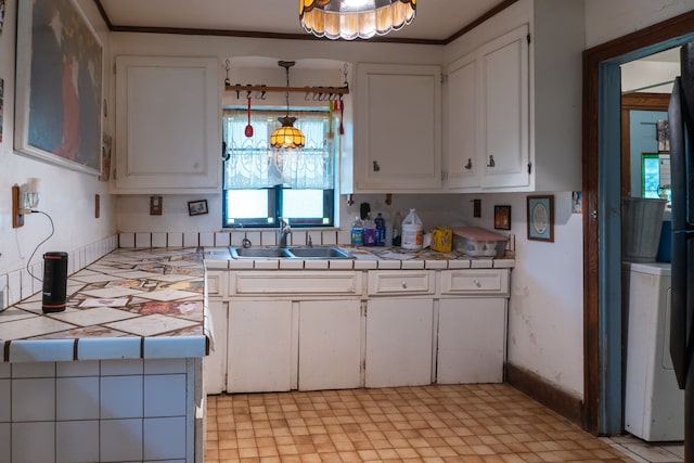37539 Palmer Woods Blvd, Sterling Heights, MI 48312 - kitchen with tile counters, a sink, white cabinets, and washer / clothes dryer