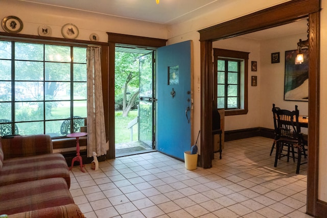 doorway to outside featuring light tile patterned flooring and a healthy amount of sunlight