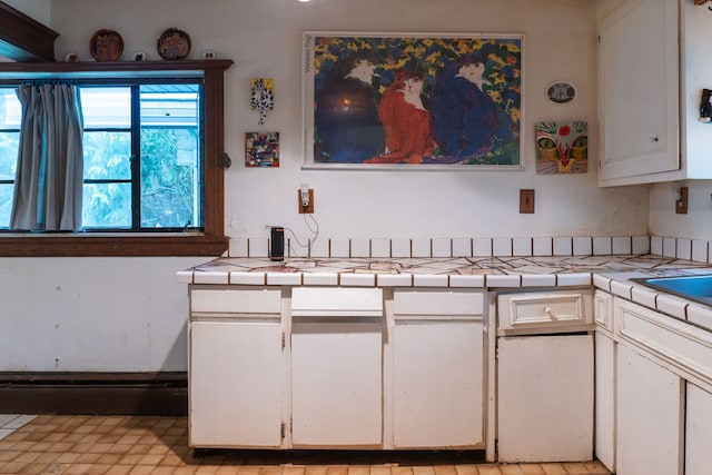 kitchen with white cabinets and tile countertops