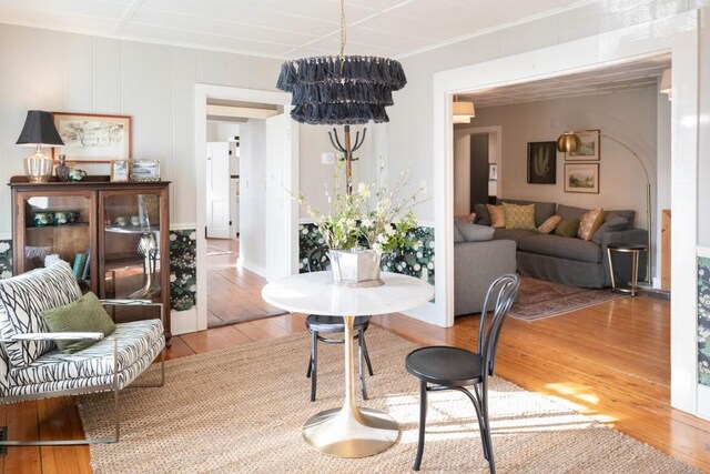 dining space with an inviting chandelier and hardwood / wood-style flooring