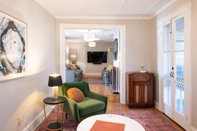 sitting room featuring french doors and hardwood / wood-style flooring