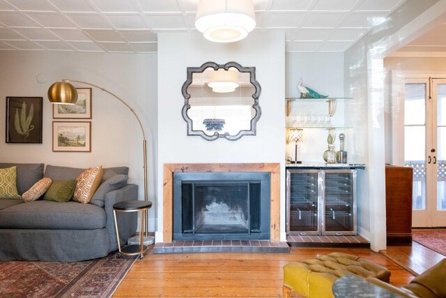 living room with beverage cooler and hardwood / wood-style flooring