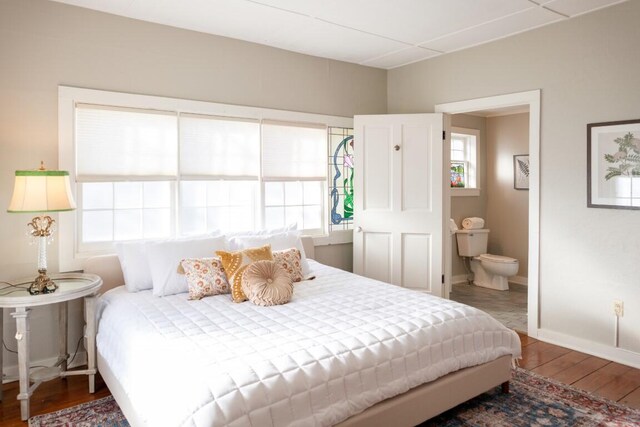 bedroom featuring wood-type flooring and connected bathroom