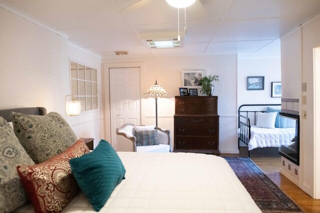 bedroom featuring hardwood / wood-style floors and crown molding