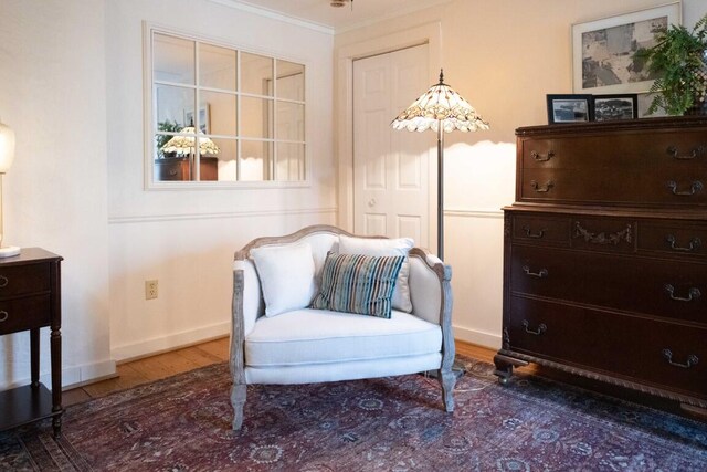 sitting room featuring dark hardwood / wood-style floors and ornamental molding