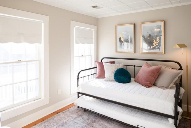 bedroom featuring hardwood / wood-style flooring and multiple windows