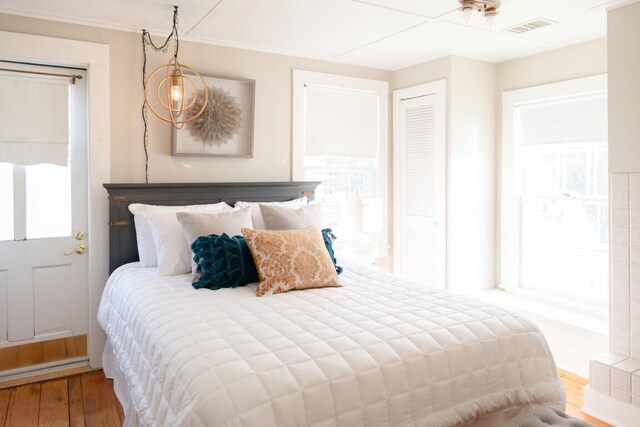 bedroom featuring hardwood / wood-style flooring and an inviting chandelier