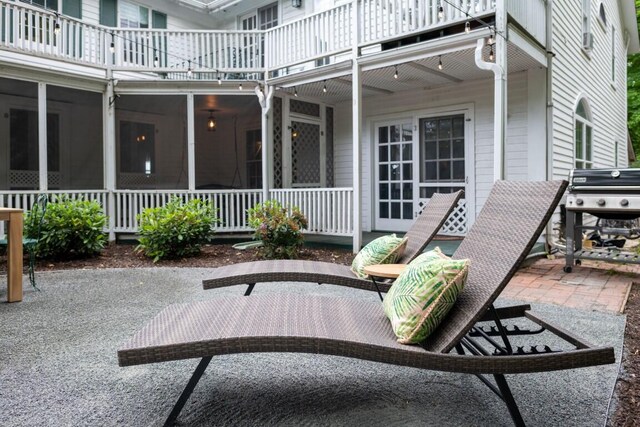 view of patio with a balcony, grilling area, and a sunroom