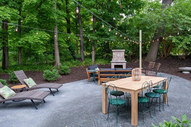 view of patio with an outdoor stone fireplace