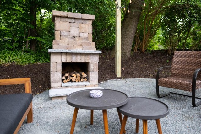 view of patio with an outdoor stone fireplace