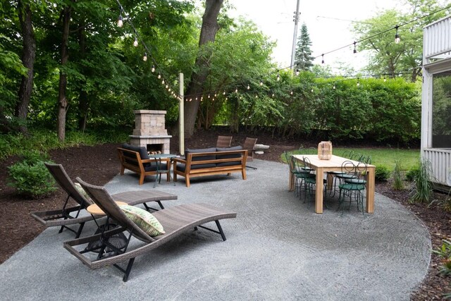 view of patio / terrace featuring an outdoor stone fireplace